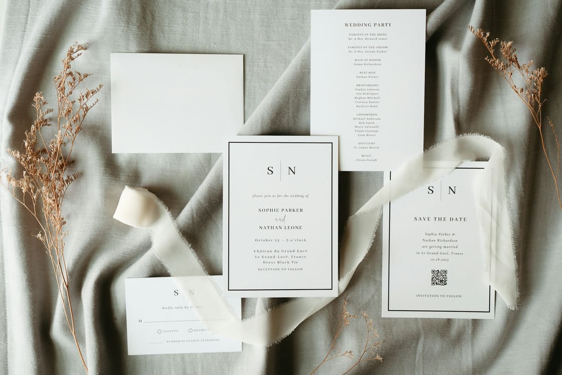 Minimal wedding invitation suite with save-the-date, RSVP card and ribbon on linen